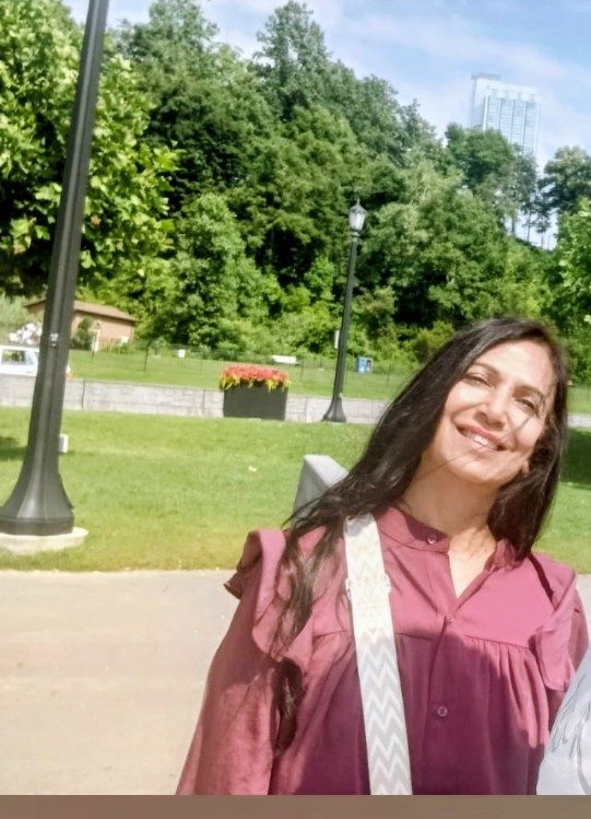 Neetu smiling warmly outdoors
