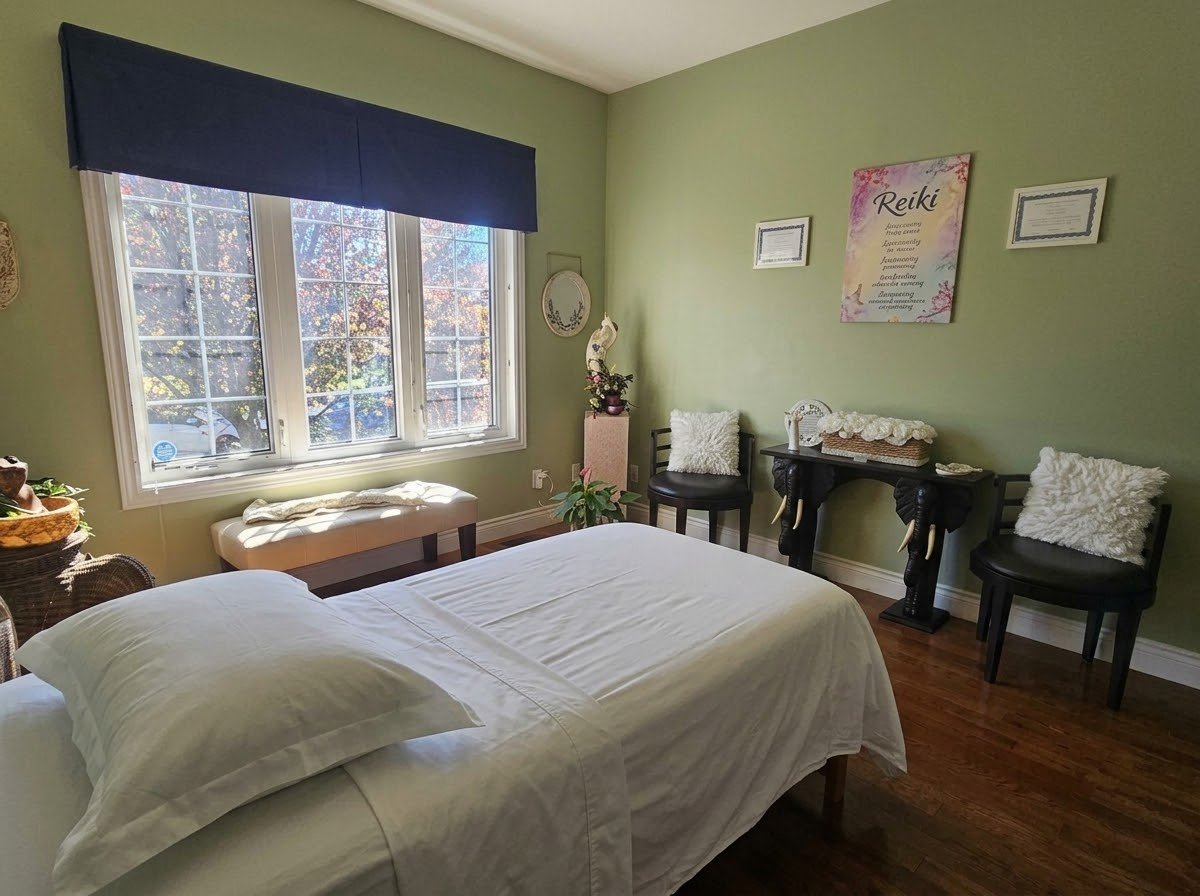 Neetu's private home Reiki studio in Whitby, with a Reiki wall hanging and framed certifications